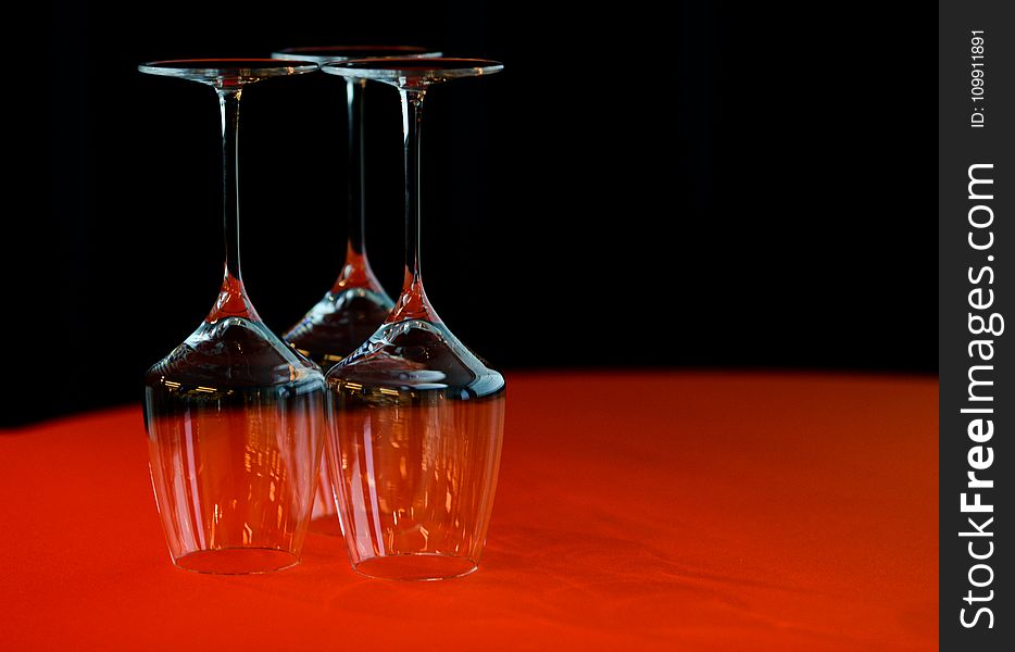 Three Wine Glass On Red Surface