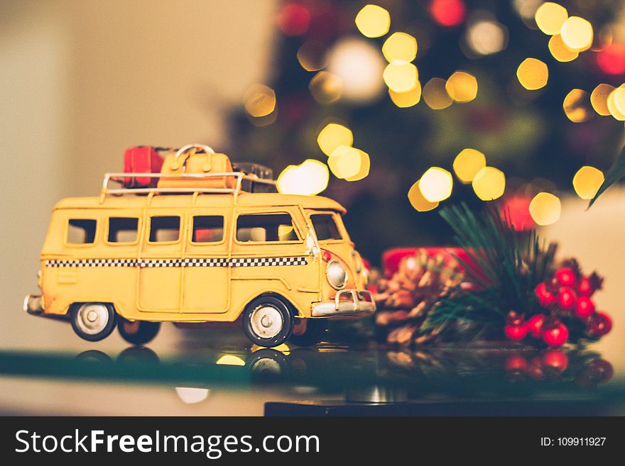Selective Focus Photography of Yellow Vehicle Scale Model