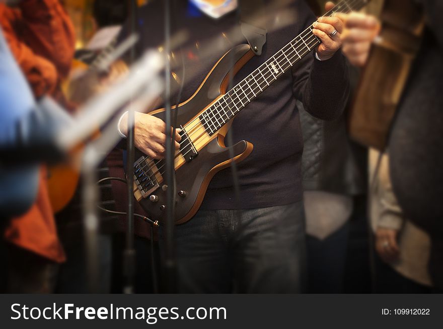 Man Holding Electric Bass Guitar