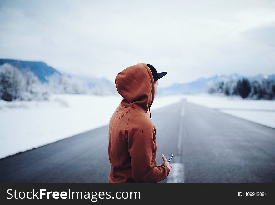 Man Wearing Brown Hoodie In Road