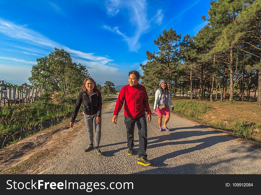 Man and Two Women Walking