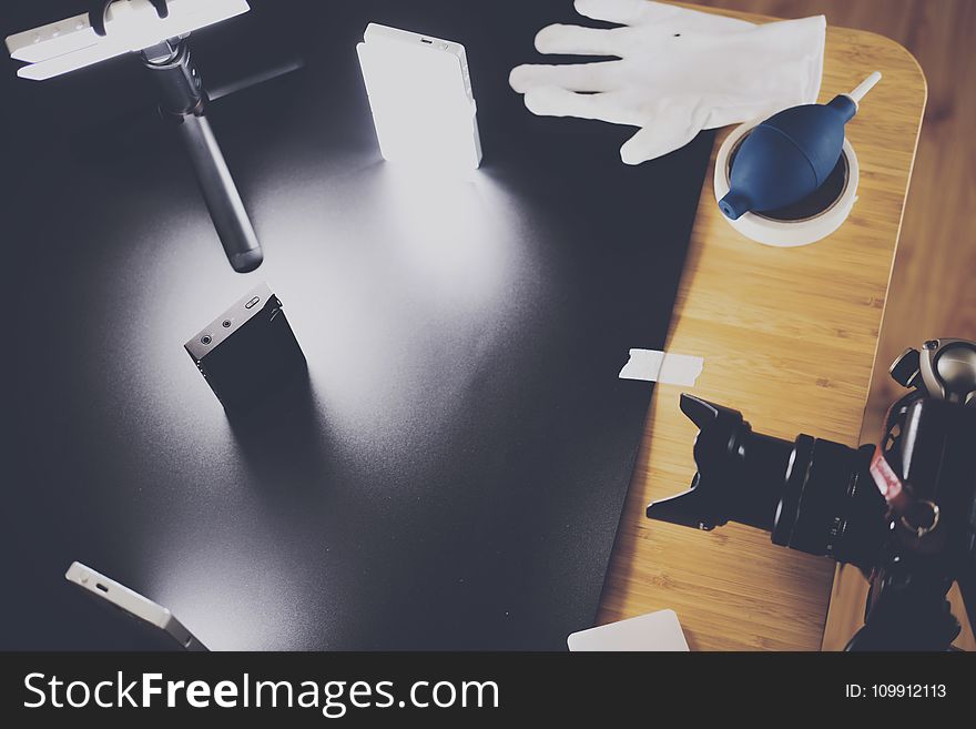 Black Dslr Camera On Top Of Brown Wooden Table