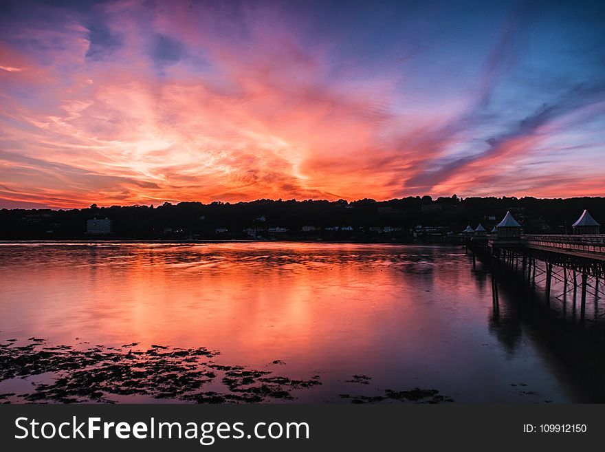 Landscape Body Of Water Near Dock During Night Time