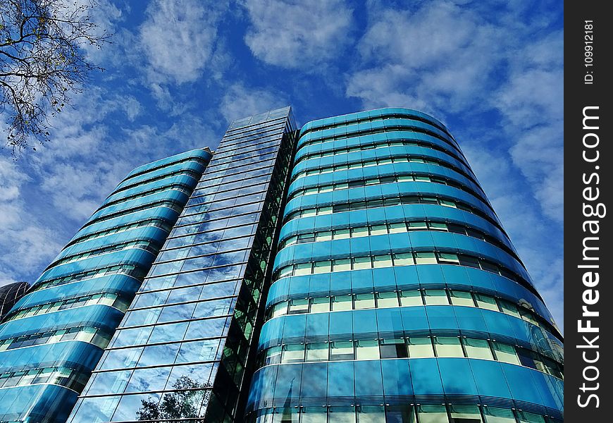 Low Angle Photography of Blue Tinted Glass Buildings