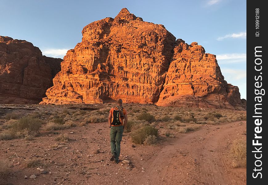 Person Wearing Orange Shirt And Green Pants