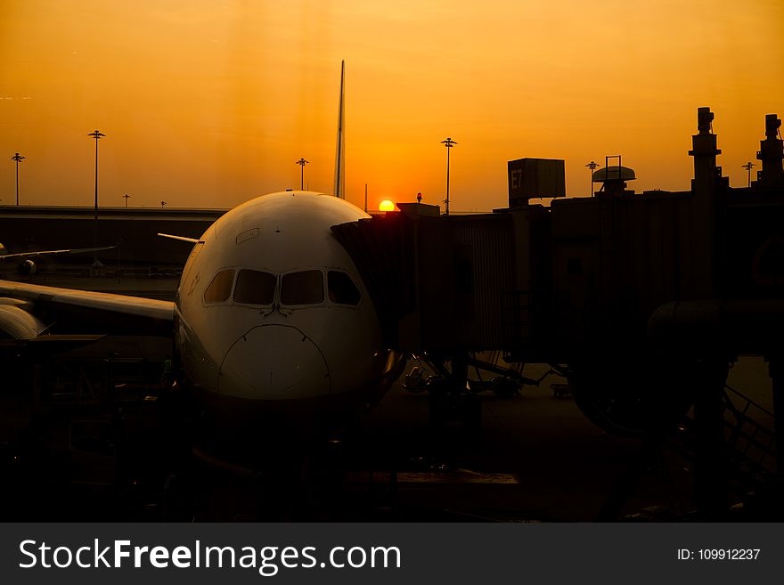 Silhouette of Airplane on Airport during Sunset