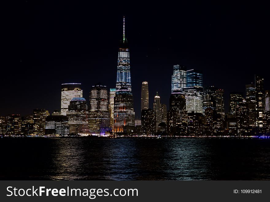 Skyline Beside The Body Of Water At Night Time