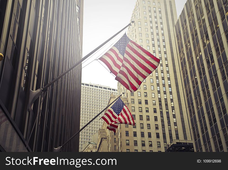 Two U.s.a. Flags Under White Clouds at Daytime