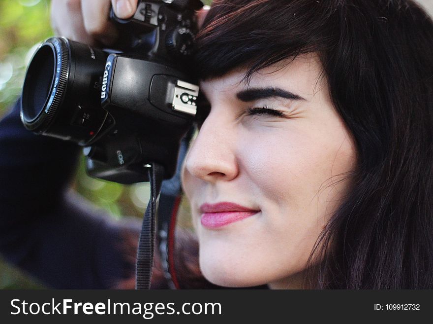 Woman Taking a Photo With Canon Dslr Camera