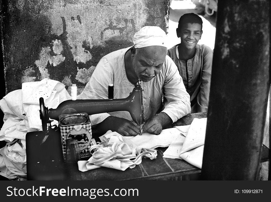 Person Sewing Cloth On Sewing Machine