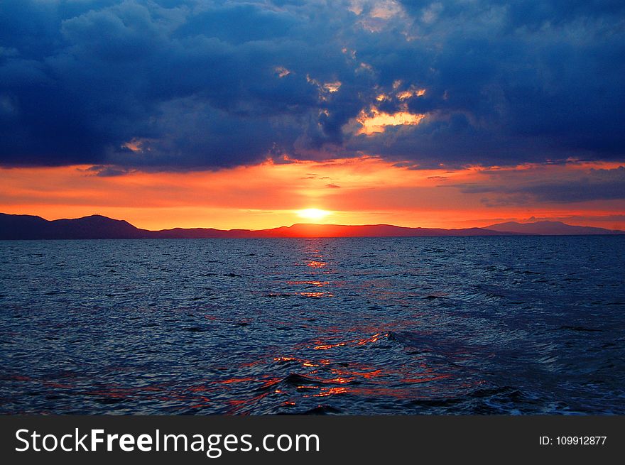 Photo of Sunset over Large Body of Water