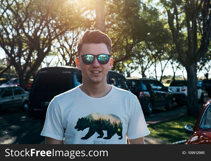 Man Wearing White and Black Bear Printed Shirt and Sunglasses