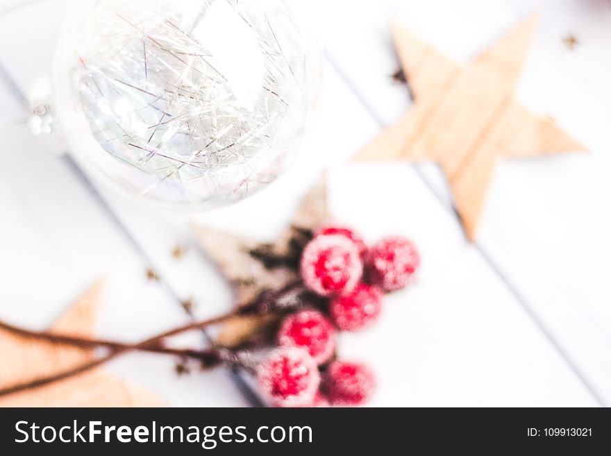 Selective Focus Photo of Clear Bauble Seeing Red Mistletoe