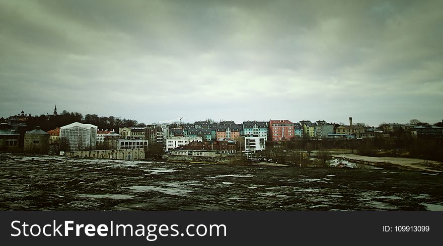 Assorted Color Concrete Building Under Cloudy Sky