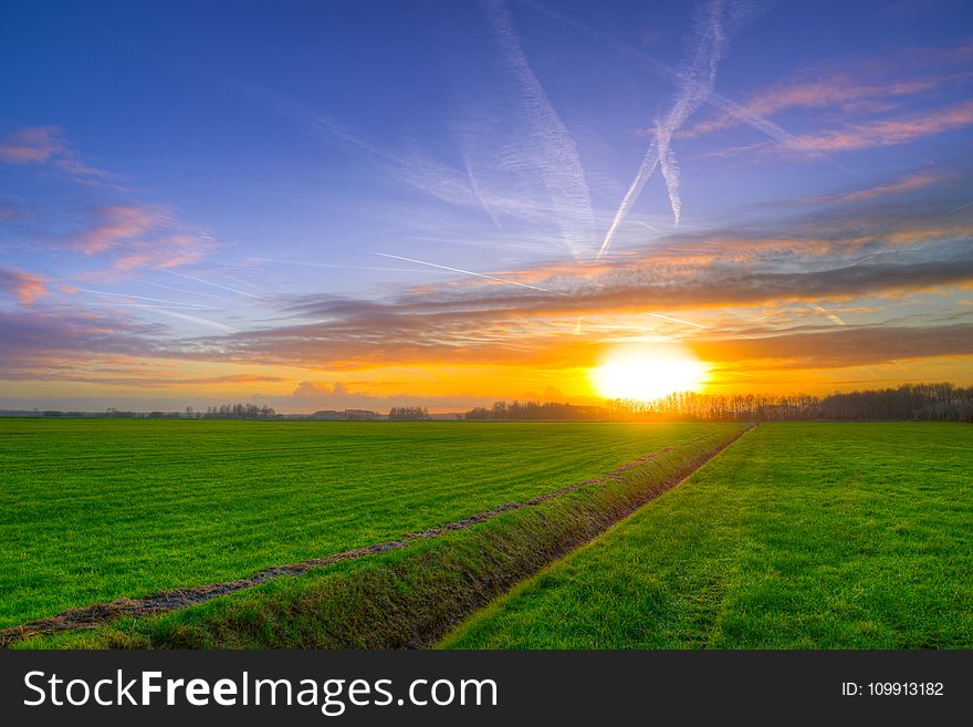 Photography Of Green Grass Field During Golden Hour