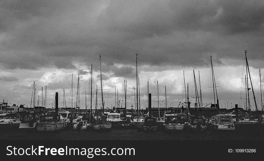 Gray Scale Photo of Group of Boats