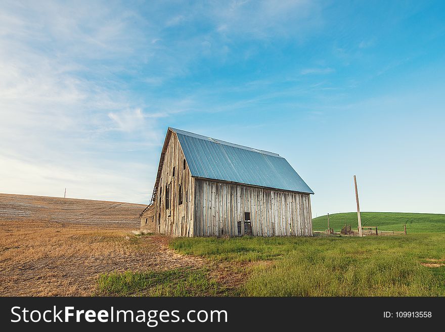 Photo of Beige and Gray Wooden Barn House on Green Grass