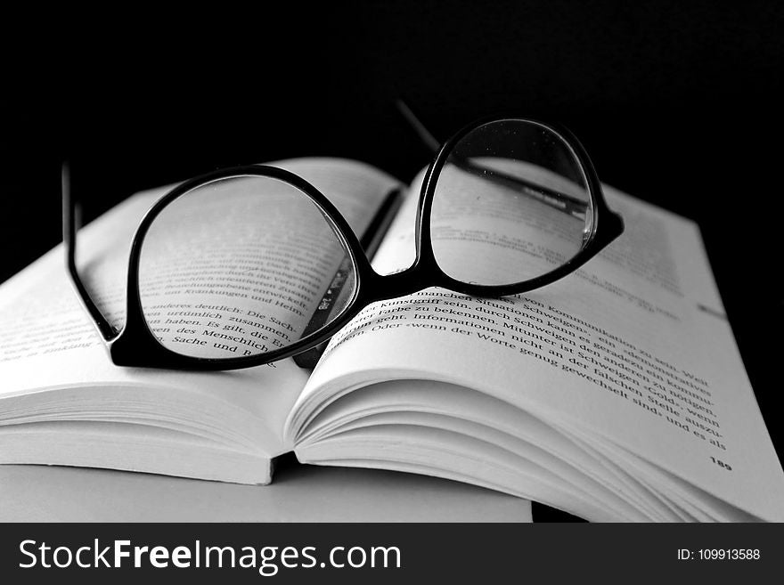 Black Framed Wayfarer Eyeglasses on Book