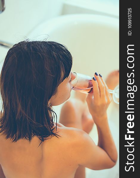 Woman On Bathtub Holding Clear Champagne Glass