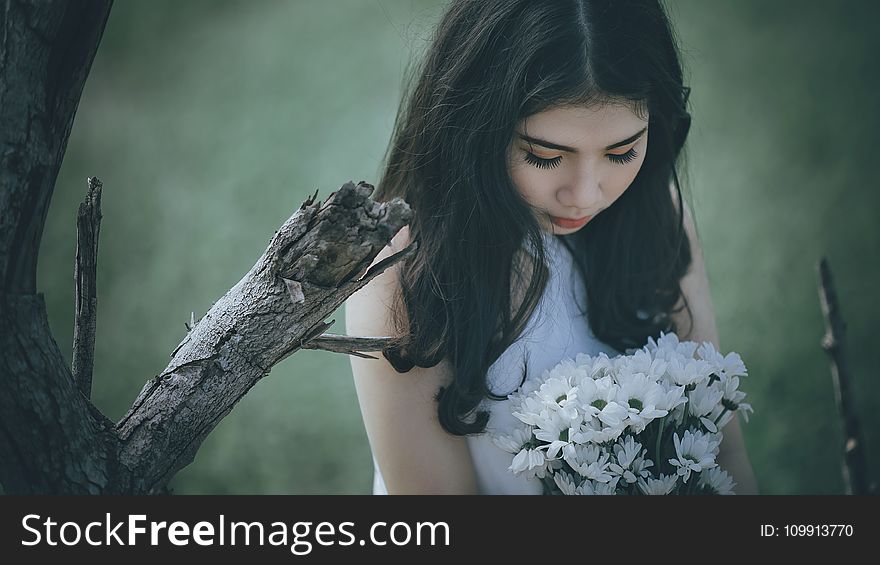 Woman Wearing White Halter Top Holding White Flower Bouquet