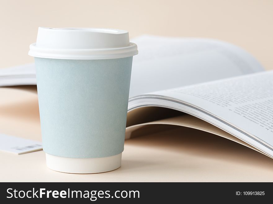 Photo of Coffee Cup Beside Book