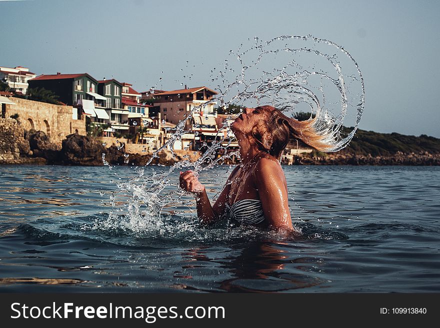 Time-lapse Photography Of Woman Playing On Water With Her Hair