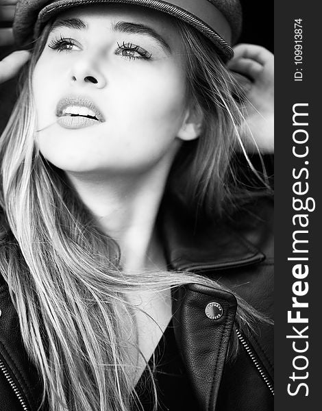 Grayscale Photography Of Woman Wears Leather Jacket And Cap