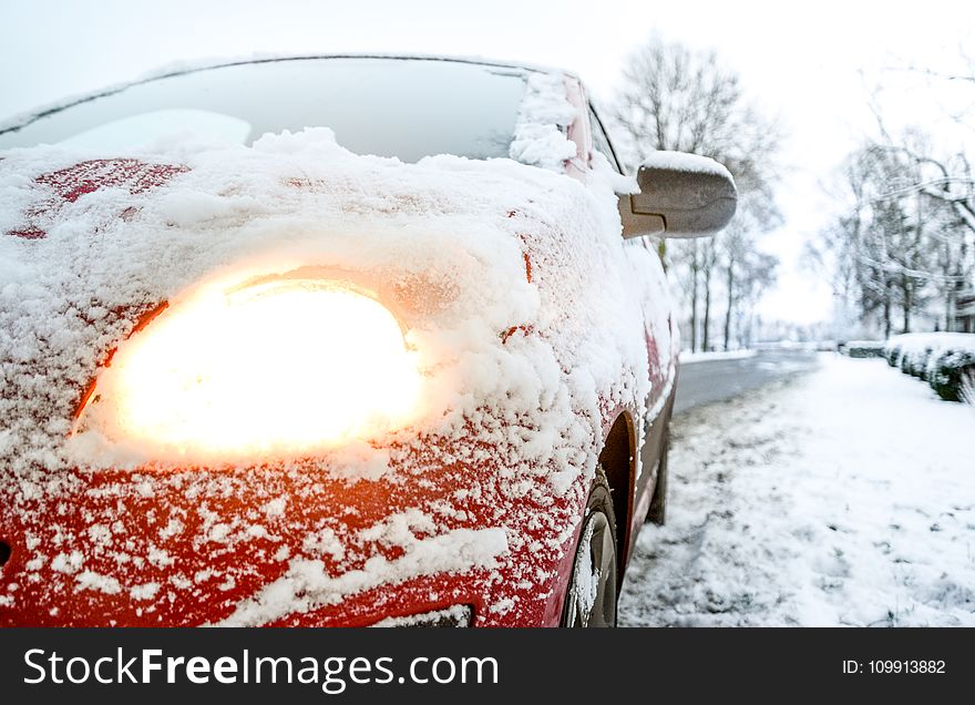 Snow Covered Red Sedan