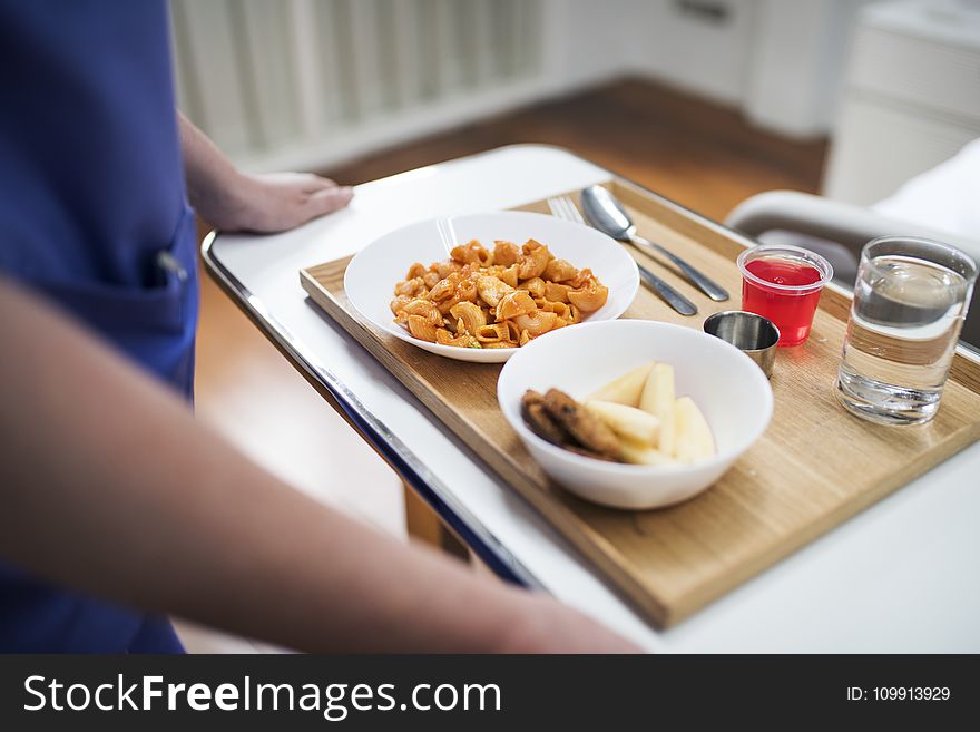 Person Standing In Front Of Food Tray