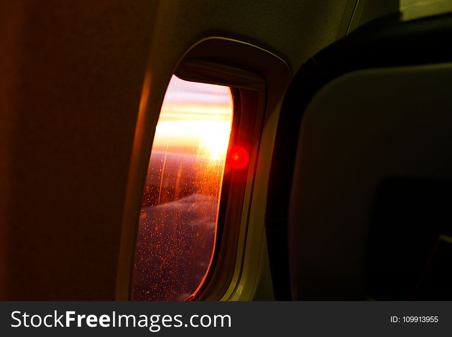 Photography of Airplane Window During Dusk