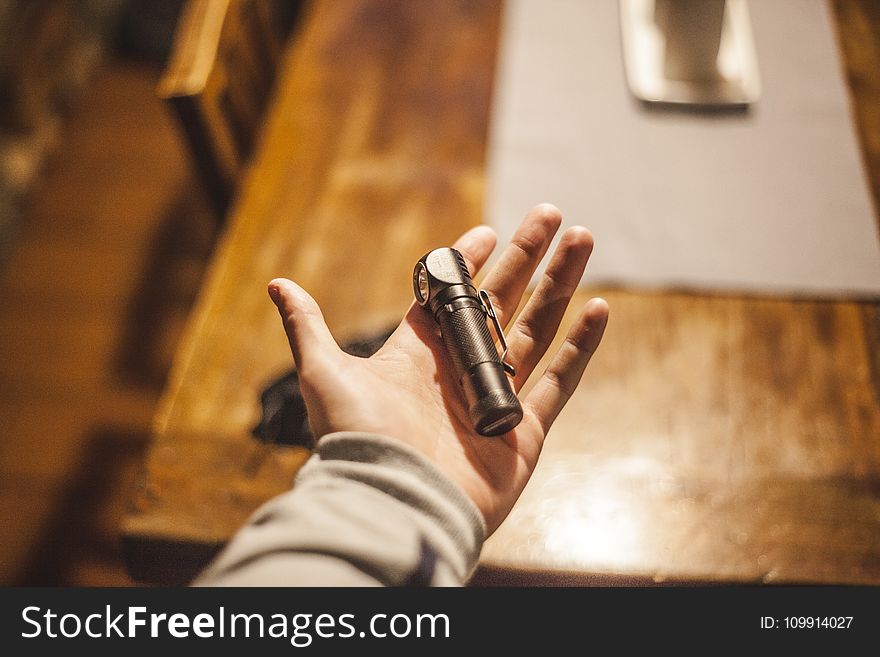 Person Left Hand Holding Stainless Steel Tool