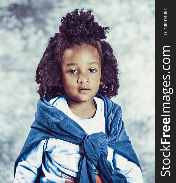 Photo of Kid With Blue Scarf and White Long-sleeve Top