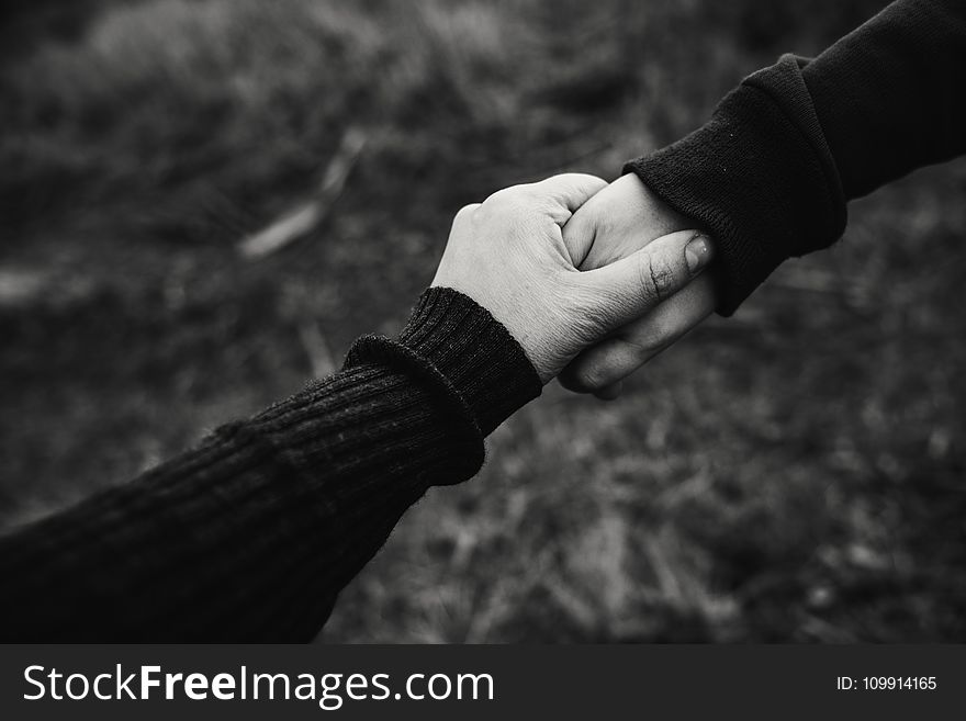 Black and White Photo of Holding Hands