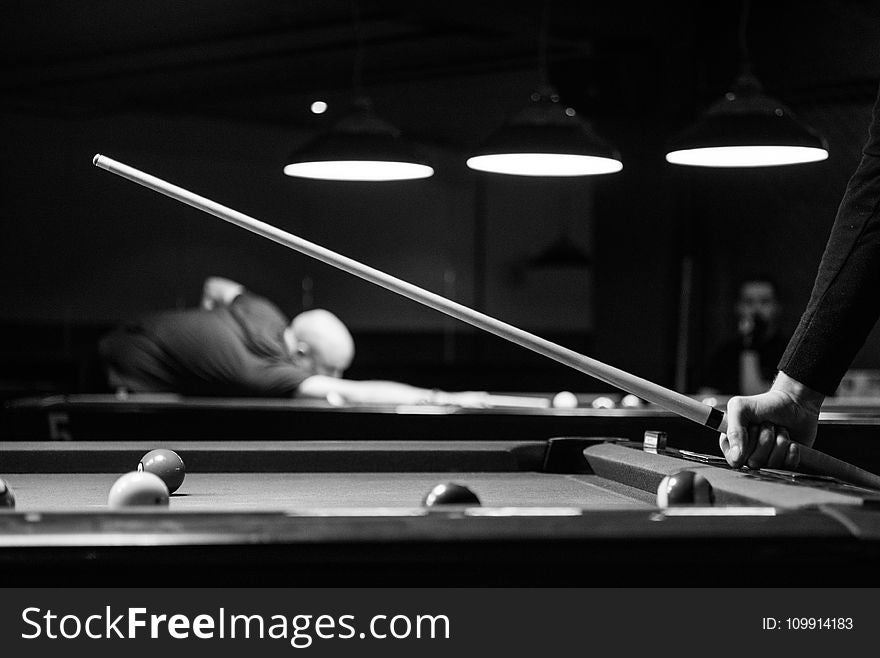 Grayscale Photo of Man Holding Cue-stick