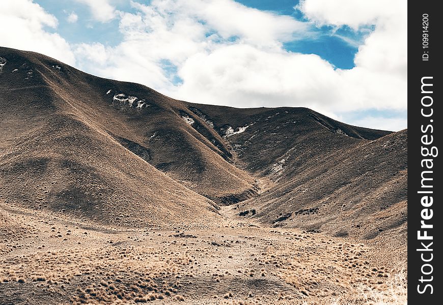 Landscape Photography Of Mountain Under White Clouds