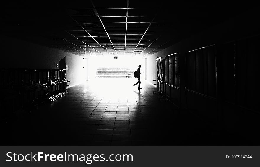 Silhouette of Man Walking on Hall