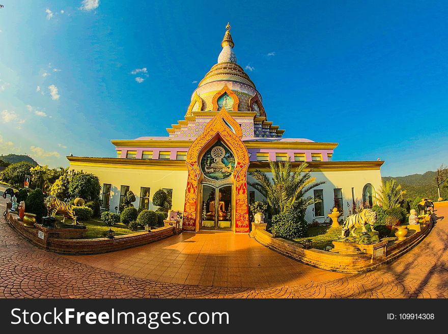 White Buddhist Temple With Blue Cloudy Background