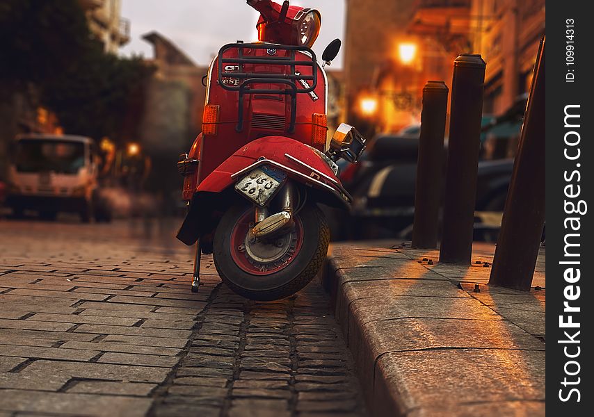 Selective Photography of Red Motor Scooter
