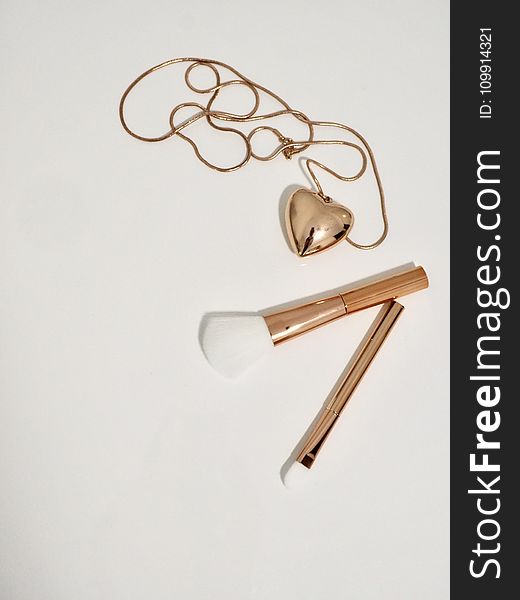 Photo of Gold Make-up Brushes and Necklace