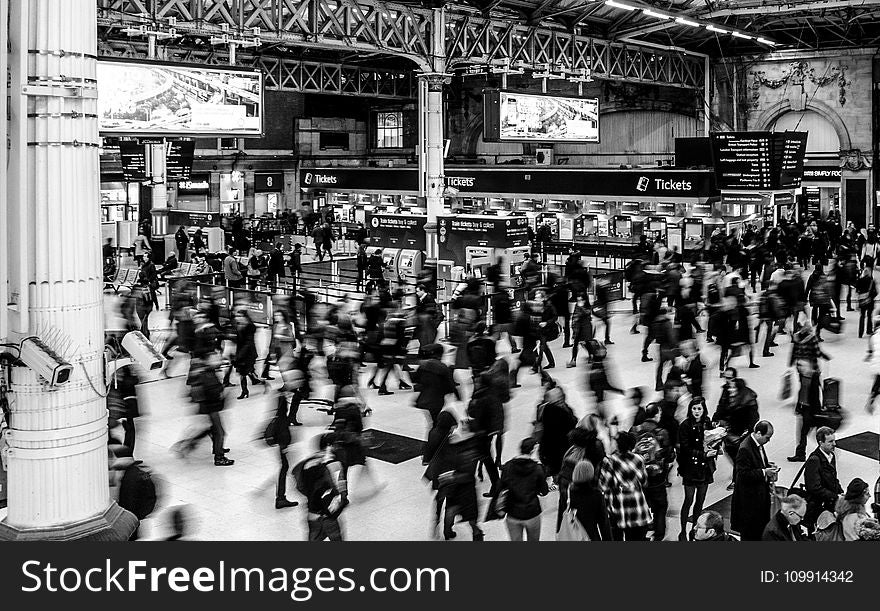 Grayscale Photography Of People Walking In Train Station