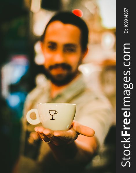 Focus Photography Of Man Holding Ceramic Teacup