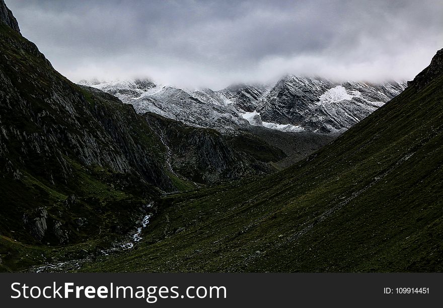 Mountain Valley Under Cloudy Sky