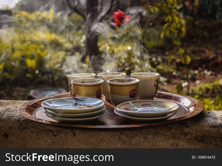 Brown Ceramic Teacups Beside Saucers on Brown Serving Plate