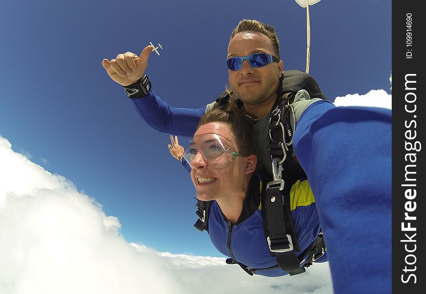 Man and Woman in Blue Jacket Doing Sky Diving