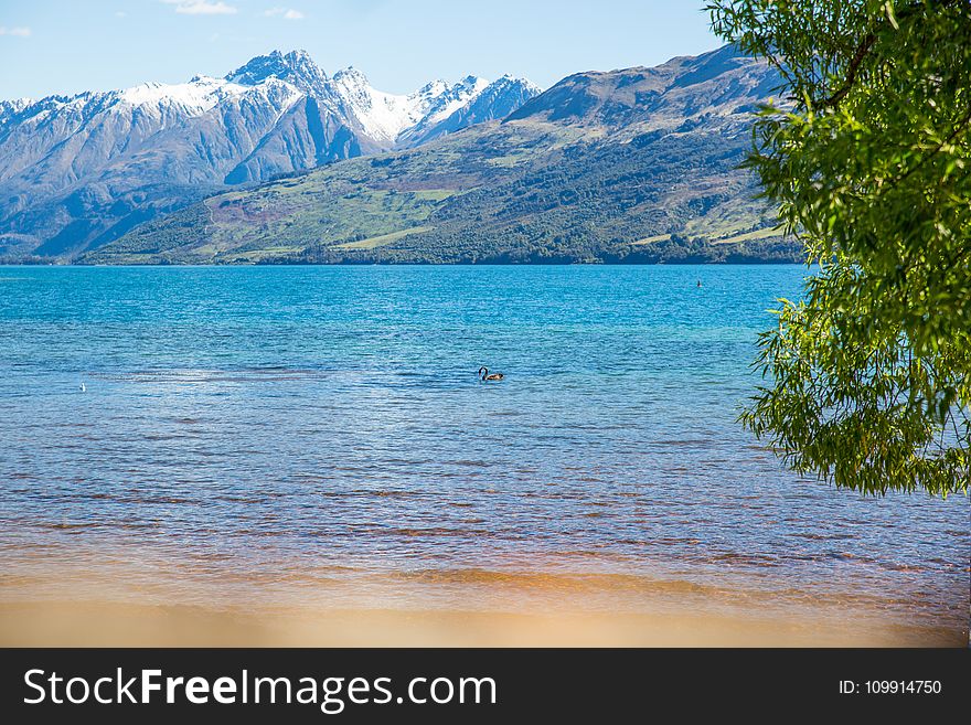 Landscape Photo of Body of Water With Mountain As Background