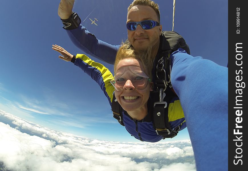 Fisheye Photography Of Man And Woman Sky Diving