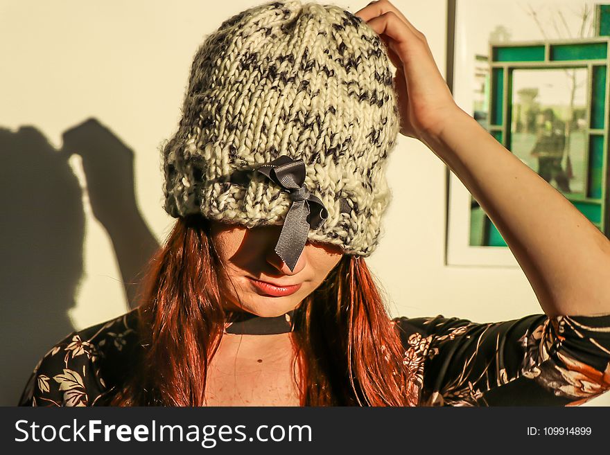 Closeup Photo of Woman Wearing White and Black Knit Cap