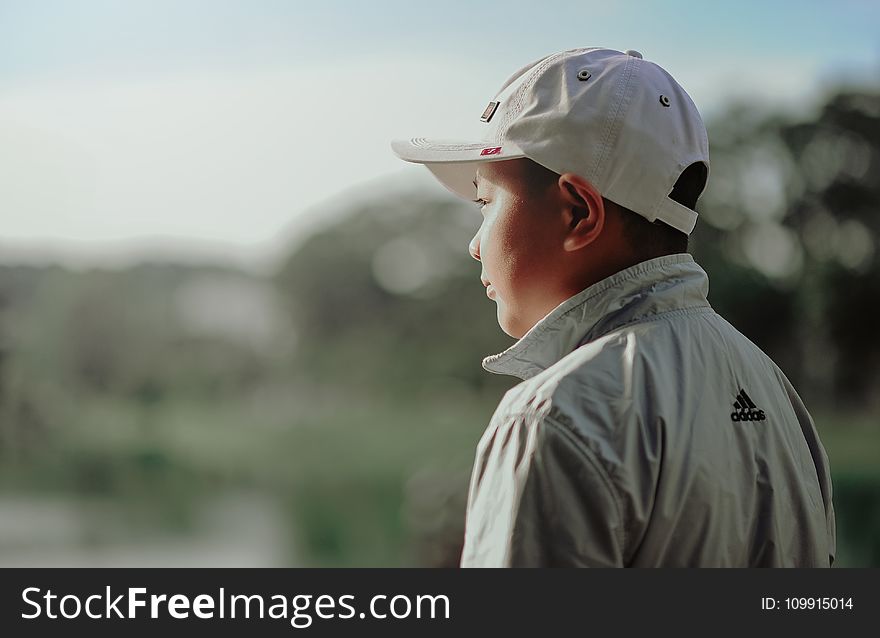 Boy Wearing Adidas Jacket and Gray Fitted Cap