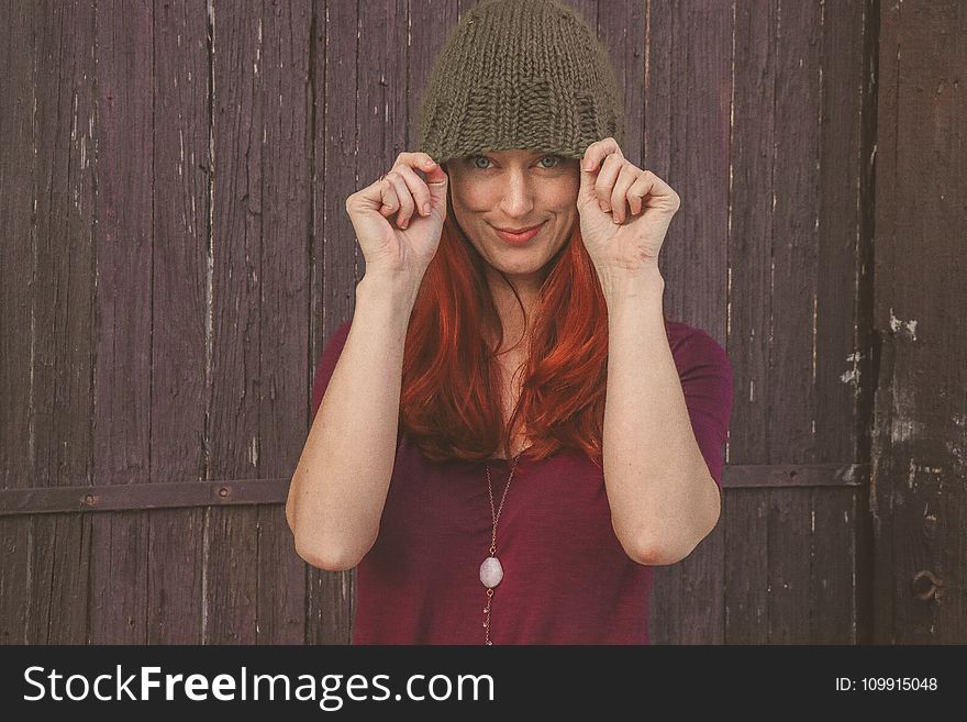 Woman Wearing Maroon Scoop-neck Shirt With Brown Knit Cap