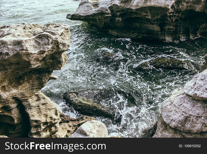 Brown Rock Formation Near Body Of Water